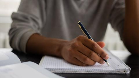 a person writing a letter