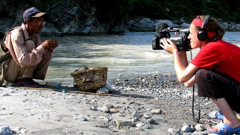 A filmmaker shoots video of a fisherman 