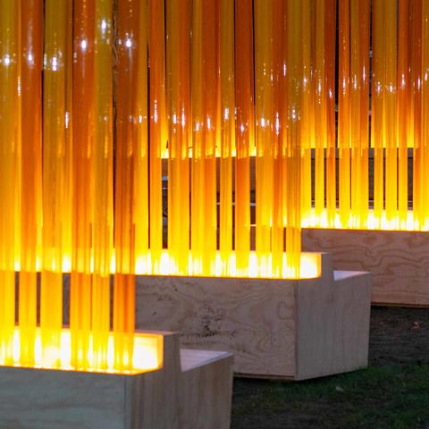 Close up of the yellow and orange tubes lit up to create the Autumn (...Nothing Personal) art installation