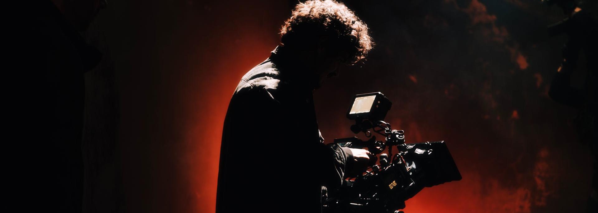 A man holding a film camera